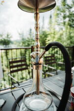 Dschinni Botan Clear Glass Hookah On Terrace Table At Quebec Cottage With Forestry Background